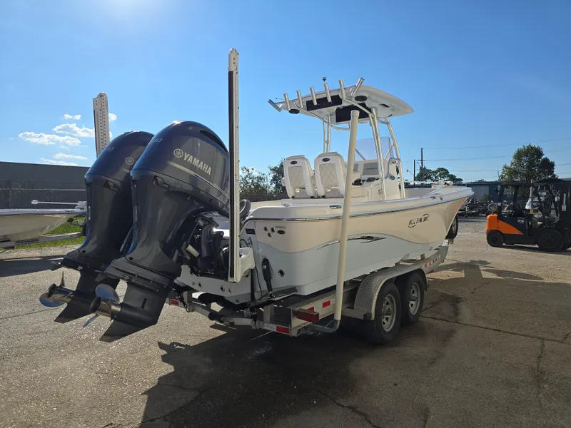 Slide: The Image of 2021 Blue Wave 2800 Makaira boat with dual Yamaha engines on a trailer. - 5