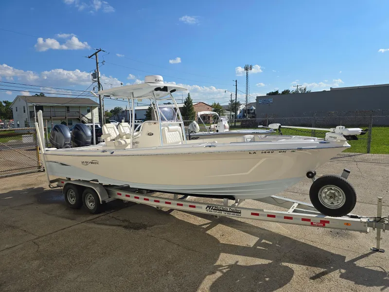 Slide: The Image of 2021 Blue Wave 2800 Makaira boat on trailer, parked outdoors under a clear sky. - 6