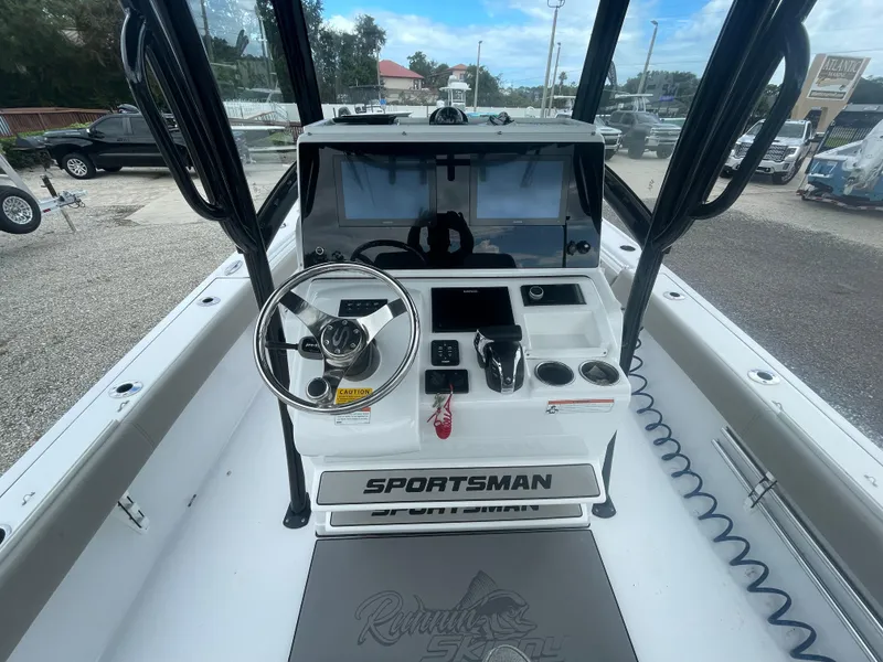 Slide: The Image of 2022 Sportsman Masters 267OE Bay Boat dashboard with steering wheel and controls. - 14