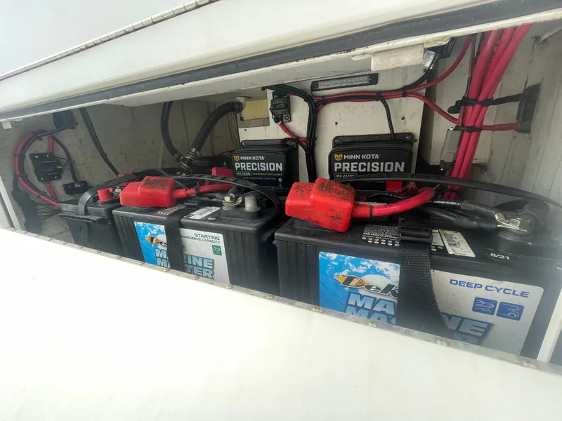 Slide: The Image of 2022 Sportsman Masters 267OE Bay Boat battery compartment with Minn Kota Precision chargers. - 17