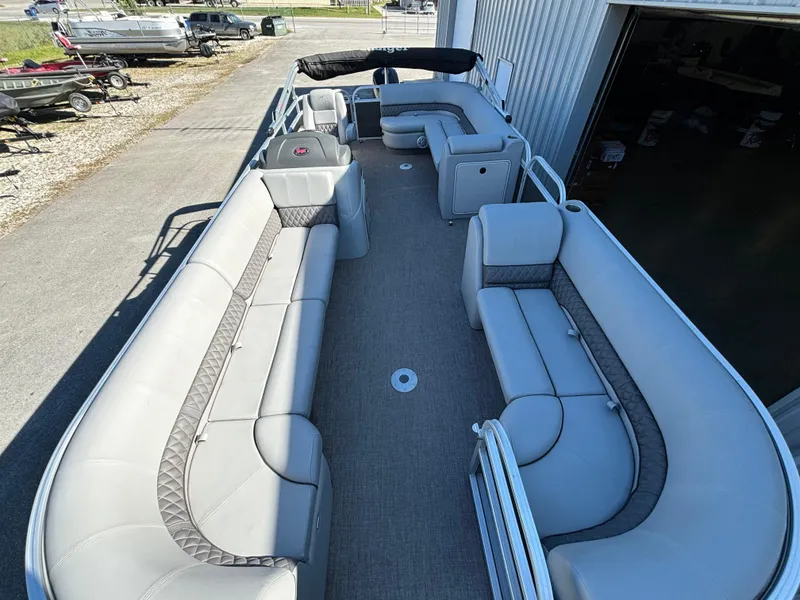 Slide: The Image of 2023 Ranger Reata 220C pontoon boat with spacious seating and modern design. - 2