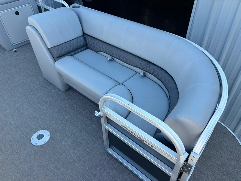 Slide: The Image of 2023 Ranger Reata 220C boat interior with gray cushioned seating and metal railing. - 4