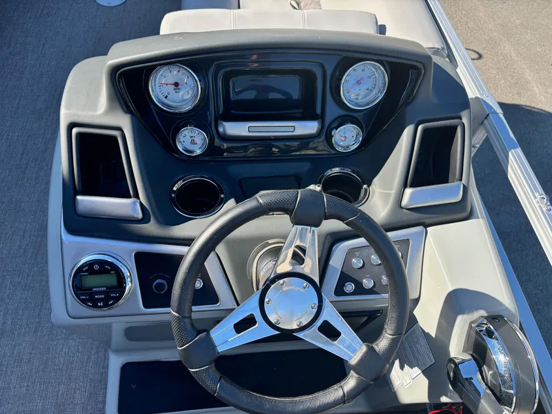 Slide: The Image of Dashboard of 2023 Ranger Reata 220C boat with steering wheel and gauges. - 6