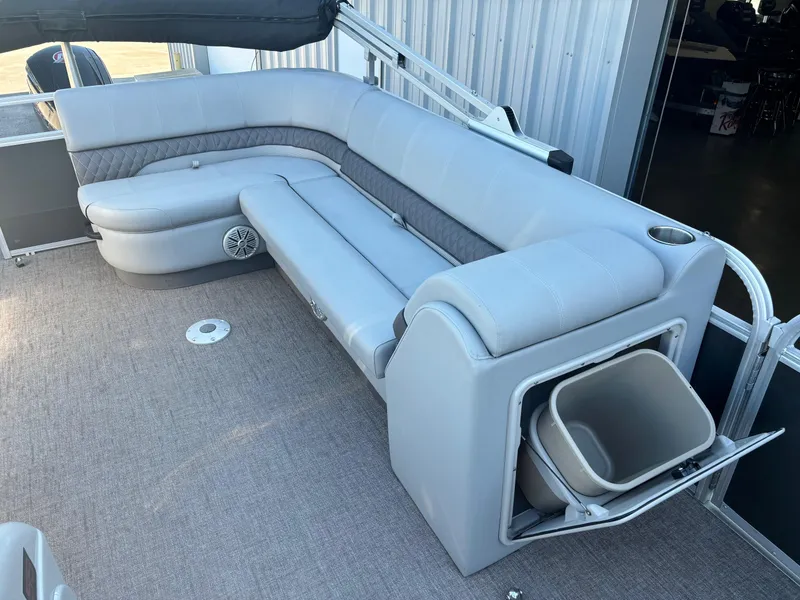 Slide: The Image of 2023 Ranger Reata 220C boat interior with gray seating and storage compartment. - 8