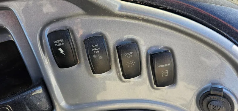 Slide: The Image of Control panel of 2023 Sun Tracker Fishin' Barge 20 DLX with switches for power and accessories. - 11