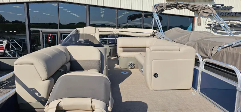 Slide: The Image of 2023 Sun Tracker Fishin' Barge 20 DLX pontoon boat with beige seating and canopy. - 2