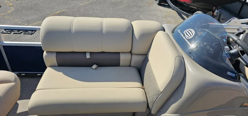 Slide: The Image of 2023 Sun Tracker Fishin' Barge 20 DLX boat interior with beige seating and console. - 5