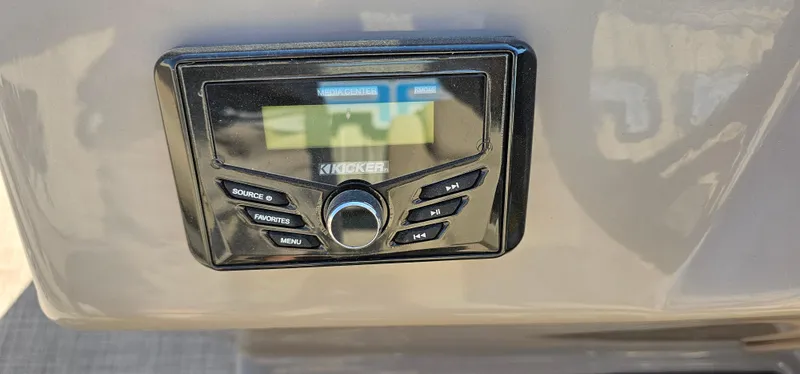 Slide: The Image of Kicker audio system on 2023 Sun Tracker Fishin' Barge 20 DLX boat dashboard. - 8