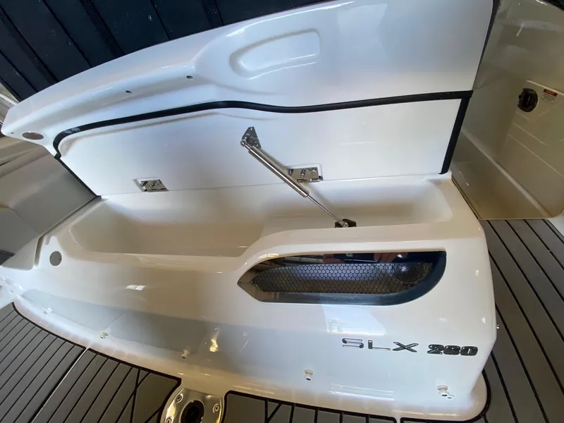 Slide: The Image of 2025 Sea Ray SLX 260 Outboard storage compartment with sleek design and modern features. - 16
