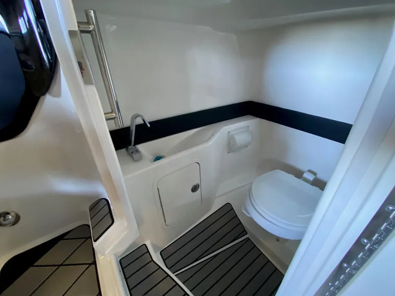 Slide: The Image of 2025 Sea Ray SLX 260 Outboard boat bathroom interior with modern fixtures. - 18