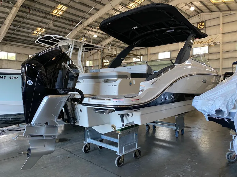 Slide: The Image of 2025 Sea Ray SLX 260 Outboard in a showroom, showcasing sleek design and powerful engine. - 3