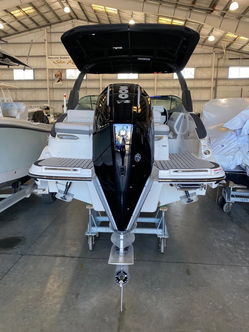 Slide: The Image of 2025 Sea Ray SLX 260 Outboard in a showroom, rear view. - 4