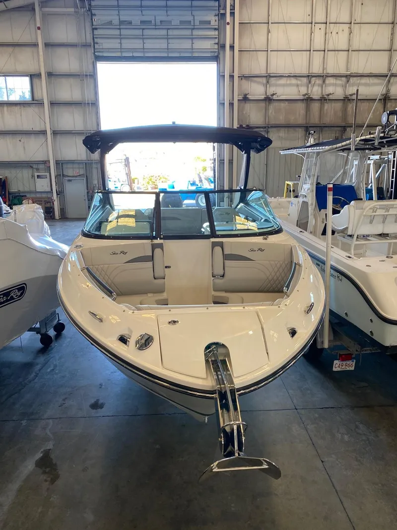 Slide: The Image of 2025 Sea Ray SLX 260 Outboard boat in a showroom, front view. - 5