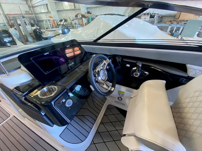 Slide: The Image of 2025 Sea Ray SLX 260 Outboard cockpit with modern steering and controls. - 8