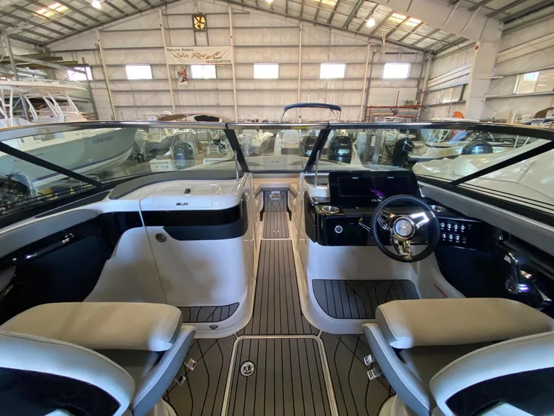 Slide: The Image of Interior view of 2025 Sea Ray SLX 260 Outboard boat in a showroom. - 9