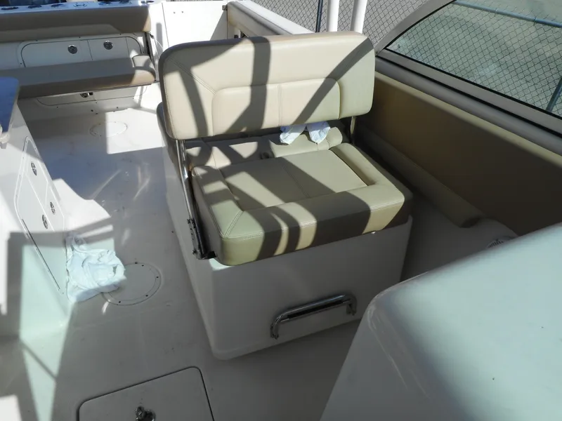 Slide: The Image of 2020 Sailfish 275 DC boat interior with beige seating and white deck. - 26