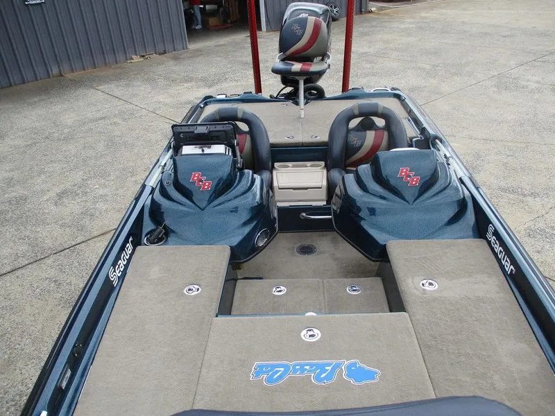 Slide: The Image of 2014 Bass Cat Puma FTD boat interior with seating and storage compartments. - 5