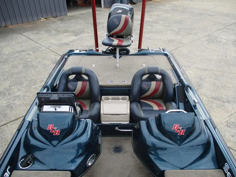 Slide: The Image of 2014 Bass Cat Puma FTD boat interior with dual seats and storage compartments. - 6