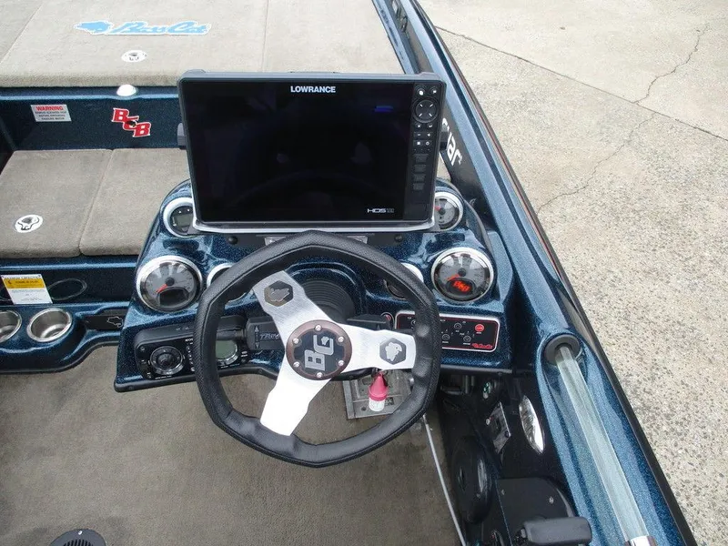 Slide: The Image of 2014 Bass Cat Puma FTD boat dashboard with Lowrance display and steering wheel. - 7