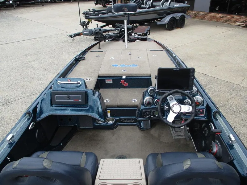 Slide: The Image of 2014 Bass Cat Puma FTD boat interior with steering wheel and dashboard controls. - 8