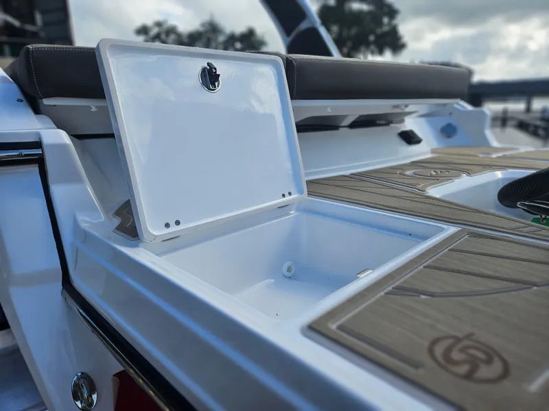 Slide: The Image of 2025 Monterey 235SS boat with open storage compartment on deck. - 12