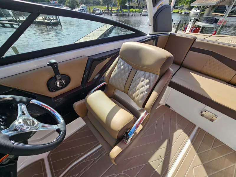 Slide: The Image of Luxurious interior of 2025 Monterey 235SS boat with plush seating and sleek steering wheel. - 25