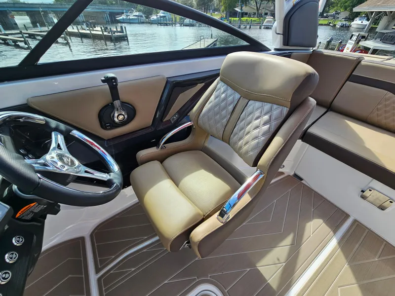 Slide: The Image of 2025 Monterey 235SS boat interior with luxurious seating and modern steering wheel. - 26
