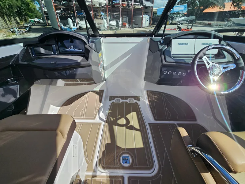 Slide: The Image of 2025 Monterey 235SS boat interior with modern dashboard and steering wheel. - 27