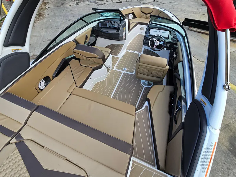 Slide: The Image of 2025 Monterey 235SS boat interior with tan seating and modern dashboard design. - 3