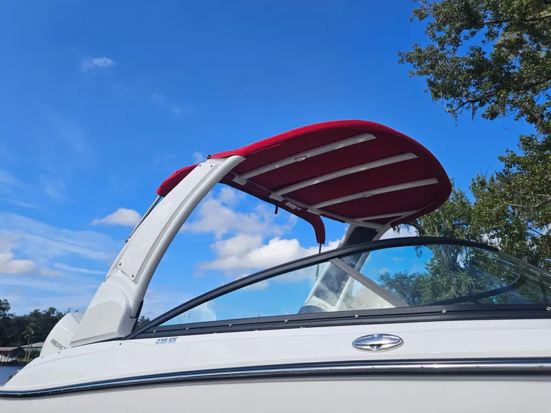 Slide: The Image of 2025 Monterey 235SS boat with red canopy against blue sky. - 6