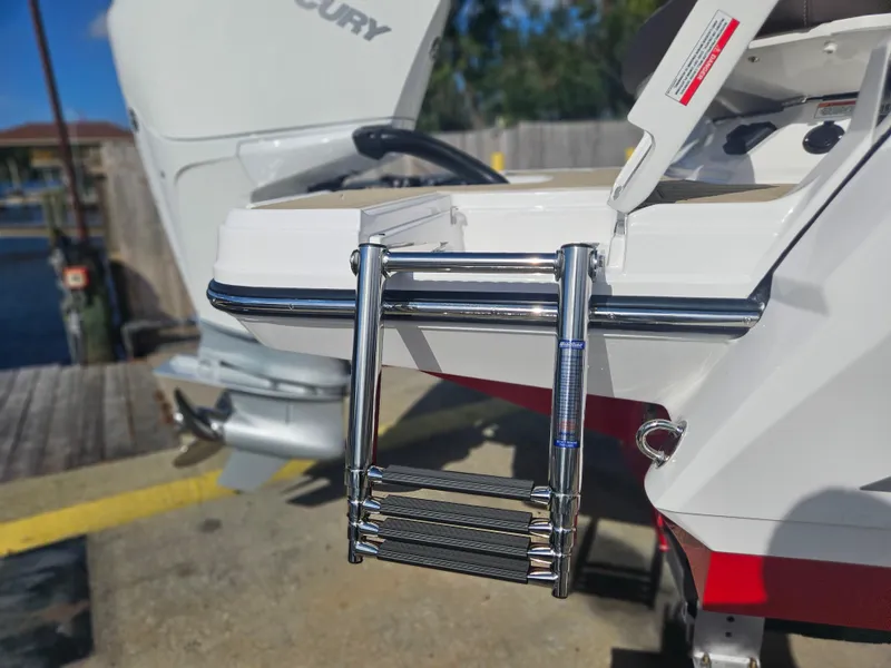 Slide: The Image of 2025 Monterey 235SS boat with a stainless steel swim ladder and Mercury outboard motor. - 8
