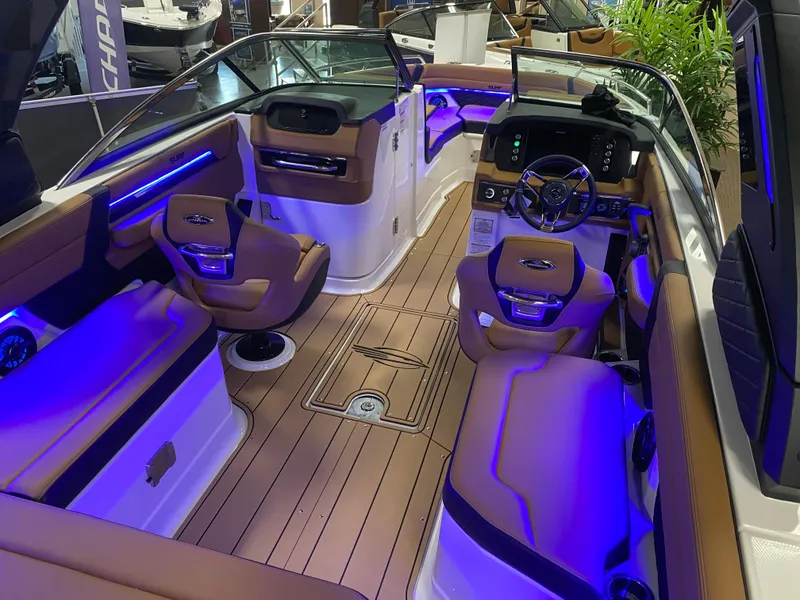 Slide: The Image of Luxurious 2025 Chaparral 26 Surf boat interior with ambient blue lighting and plush seating. - 4