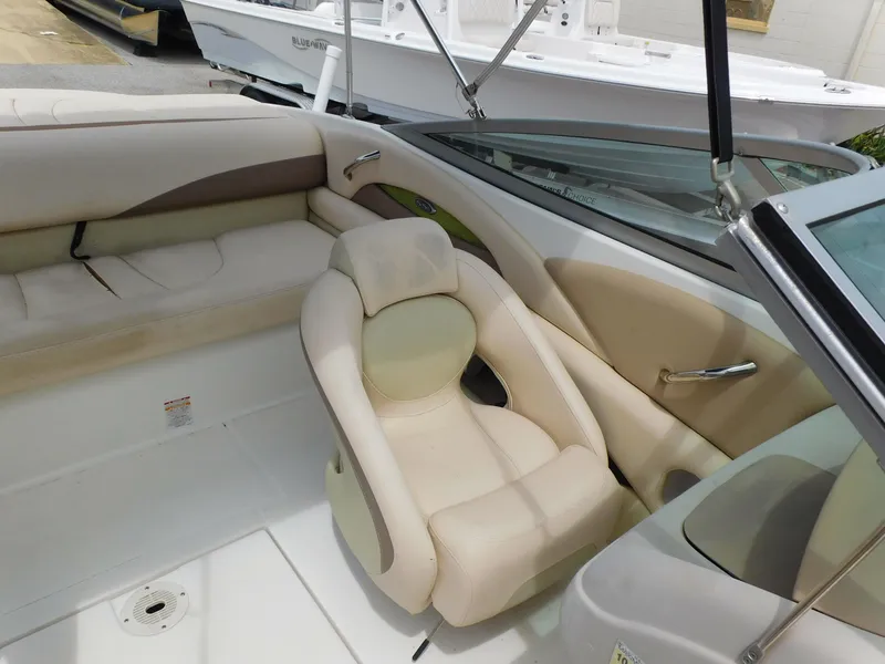 Slide: The Image of 2008 Chaparral 204 SSi boat interior with beige seating and sleek design. - 10