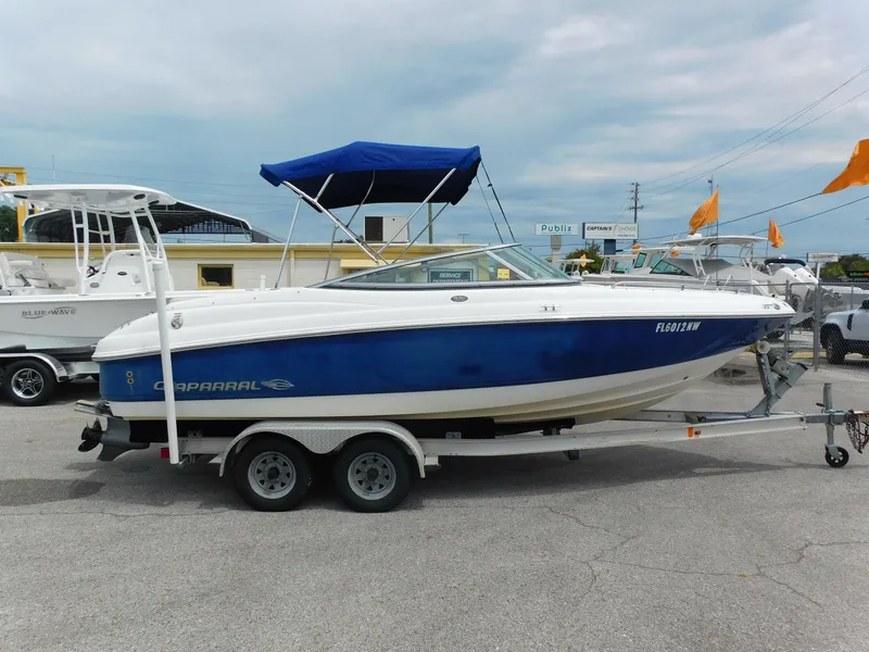 Slide: The Image of 2008 Chaparral 204 SSi boat with blue hull and trailer, parked outdoors. - 3