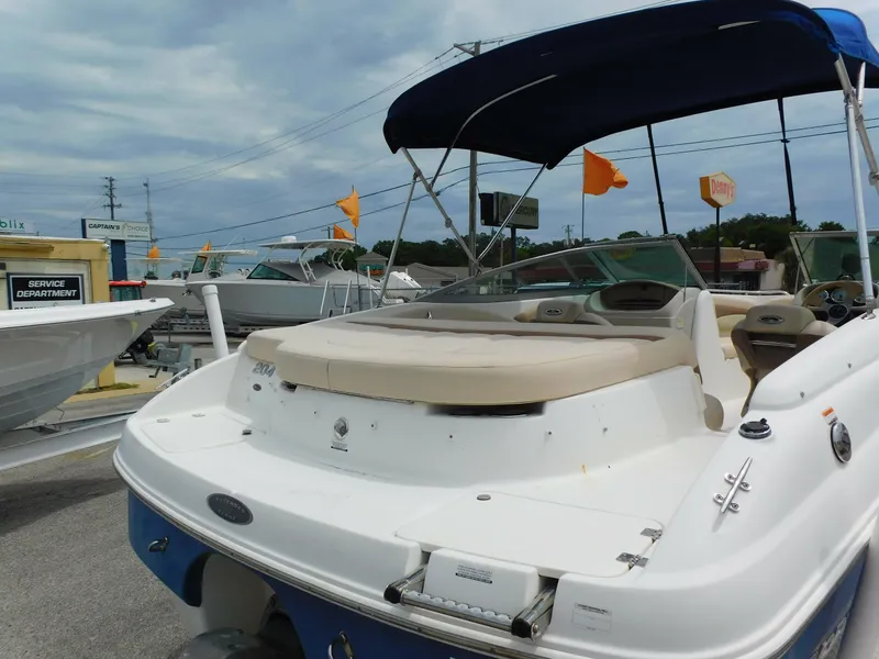 Slide: The Image of 2008 Chaparral 204 SSi boat with blue canopy in a marina setting. - 5