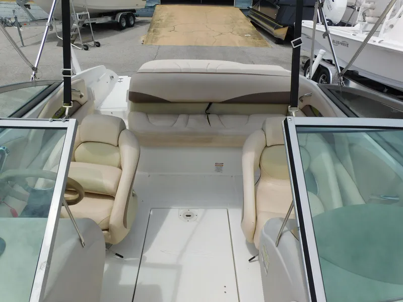 Slide: The Image of 2008 Chaparral 204 SSi boat interior with beige seating and glass windshields. - 7