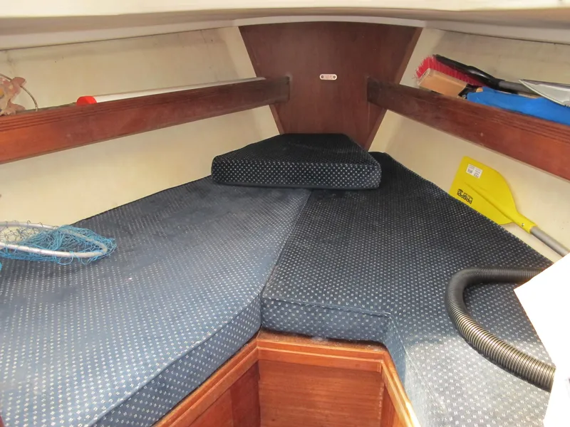 Slide: The Image of 1987 Sabre 34 sailboat interior cabin with blue cushions and wooden accents. - 11