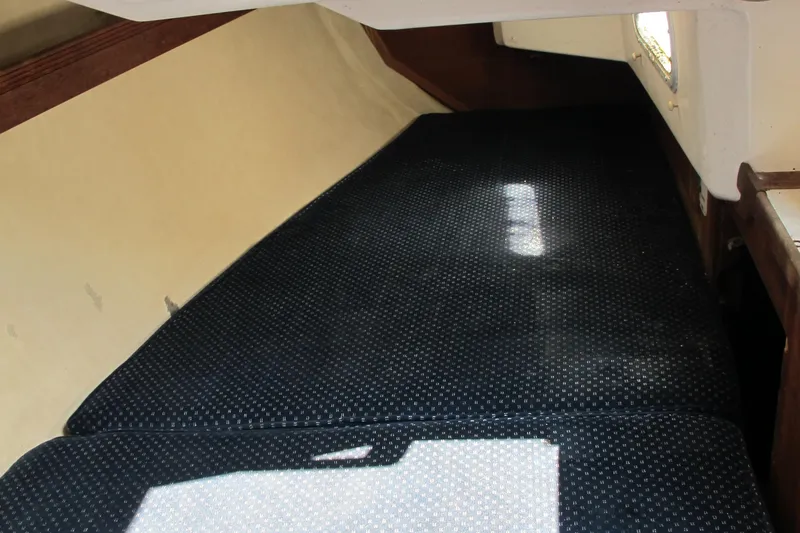 Slide: The Image of Interior cabin of 1987 Sabre 34 sailboat with dark cushioned seating. - 14