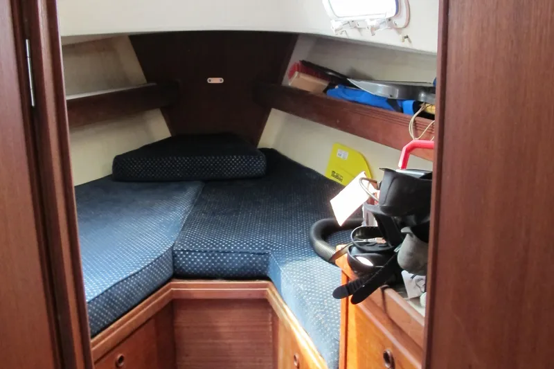 Slide: The Image of 1987 Sabre 34 sailboat cabin with blue cushions and wooden interior. - 16