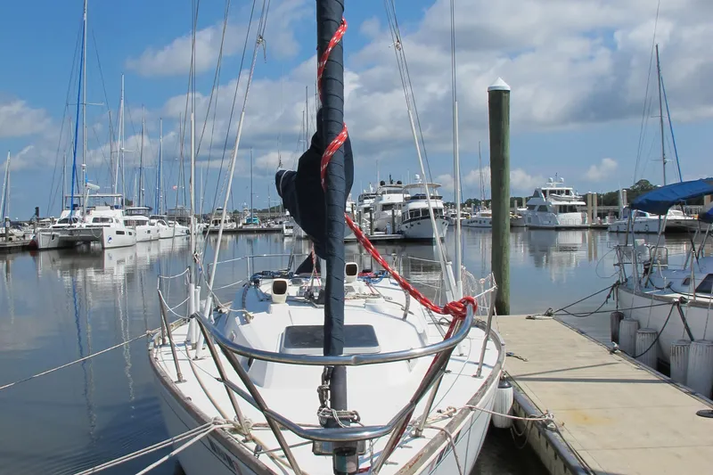 Slide: The Image of 1987 Sabre 34 sailboat docked in a marina with other boats. - 2