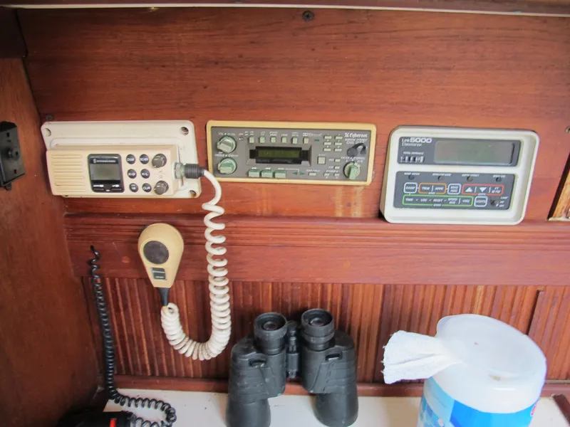 Slide: The Image of Control panel of a 1987 Sabre 34 sailboat with communication equipment and binoculars. - 5