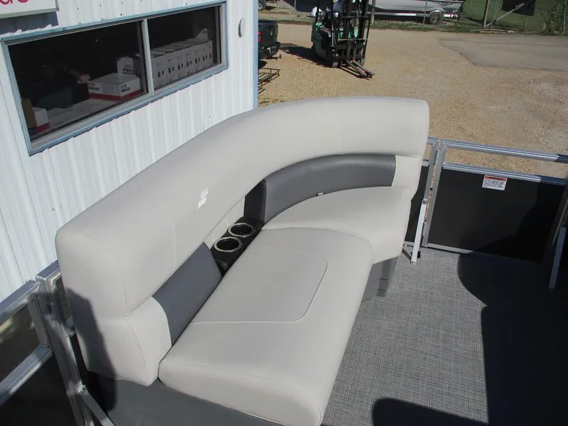 Slide: The Image of 2025 Starcraft LX 20 CB boat interior with curved seating and cup holders. - 10
