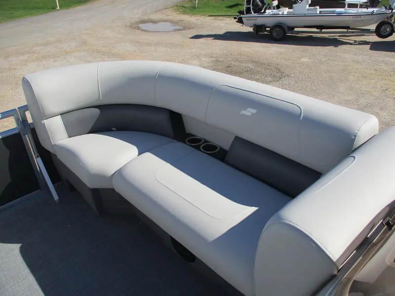 Slide: The Image of 2025 Starcraft LX 20 CB boat seating with cup holders, parked on gravel. - 11