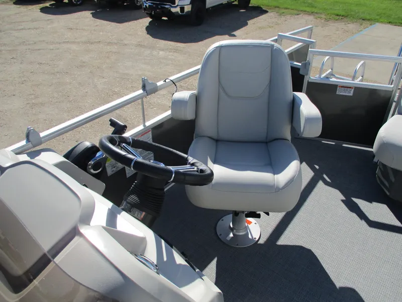 Slide: The Image of 2025 Starcraft LX 20 CB boat interior with steering wheel and captain's chair. - 13