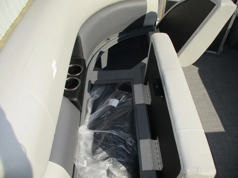 Slide: The Image of Starcraft LX 20 CB 2025 boat interior with storage and cup holders. - 14