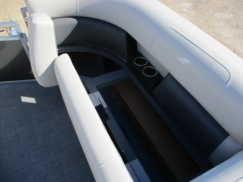 Slide: The Image of Starcraft LX 20 CB 2025 boat interior with cushioned seating and cup holders. - 15