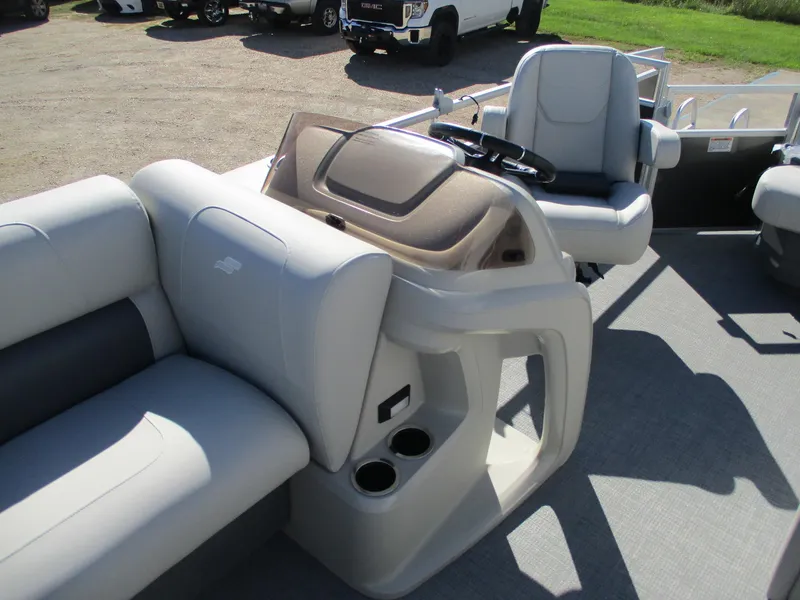 Slide: The Image of 2025 Starcraft LX 20 CB pontoon boat interior with plush seating and modern helm. - 16