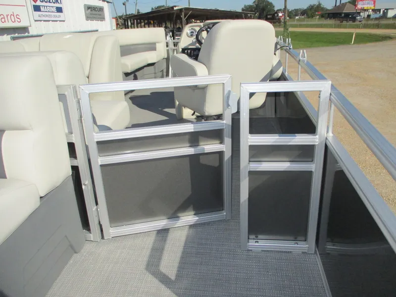 Slide: The Image of 2025 Starcraft LX 20 CB pontoon boat interior with seating and open gates. - 8