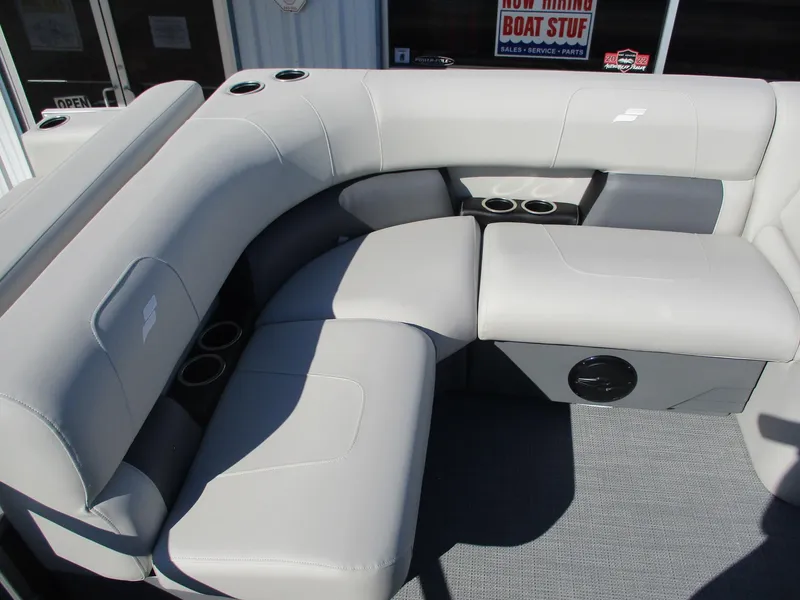Slide: The Image of 2025 Starcraft LX 20 CB boat interior with gray seating and cup holders. - 9