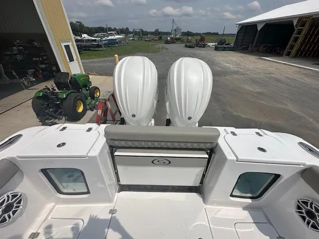 Slide: The Image of 2025 Sportsman 282 Open boat with dual engines, docked near farm equipment. - 10